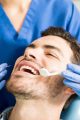 mid-adult-patient-receiving-dental-treatment-with-tools-from-female-dentist-clinic-min-min